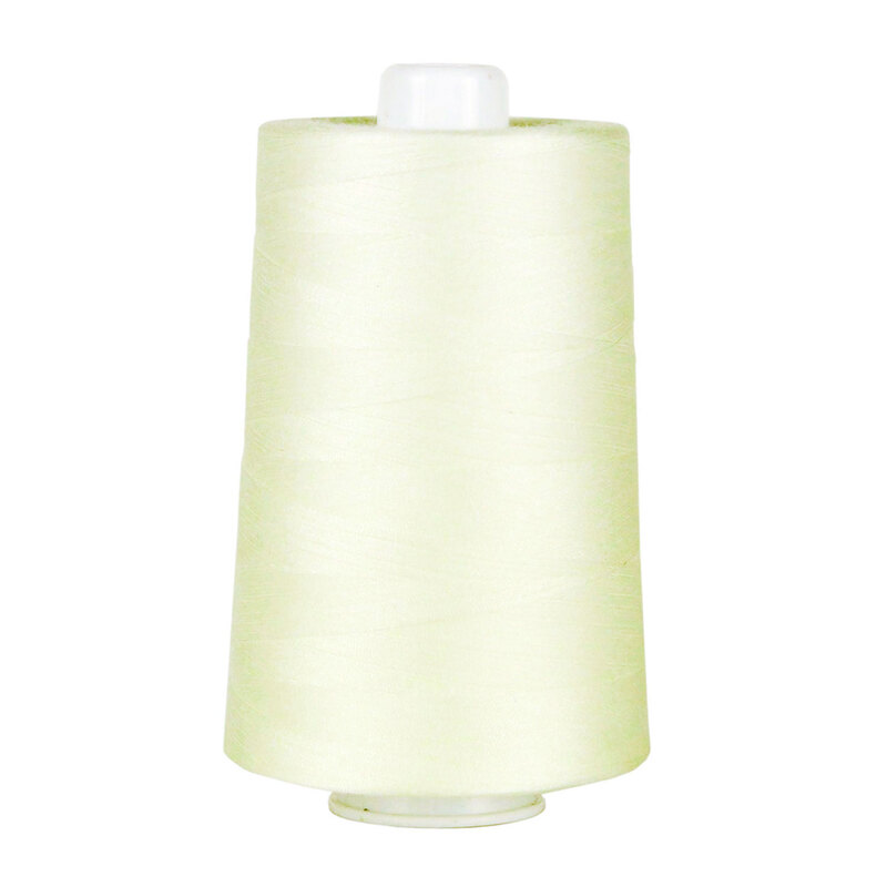 Large spool of yellowed off-white thread on a white background