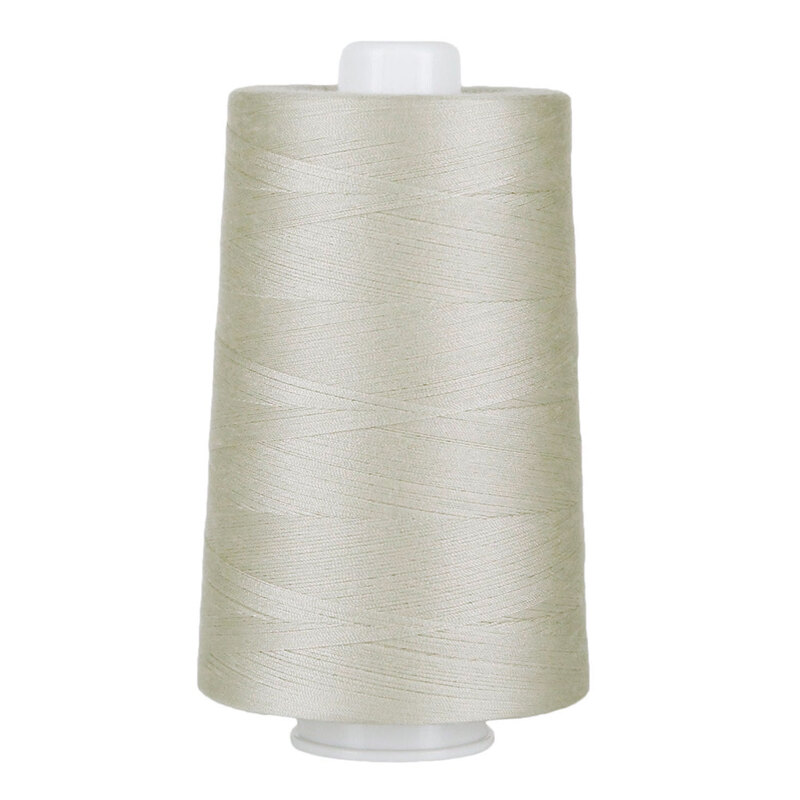 Large spool of light gray thread on a white background