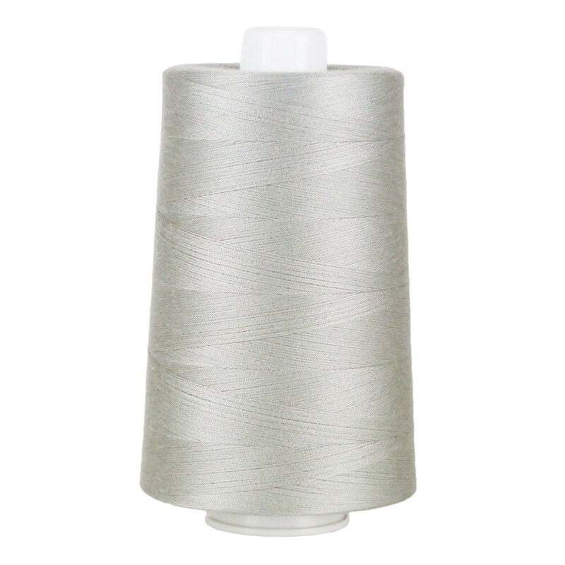 Large spool of light gray thread on a white background