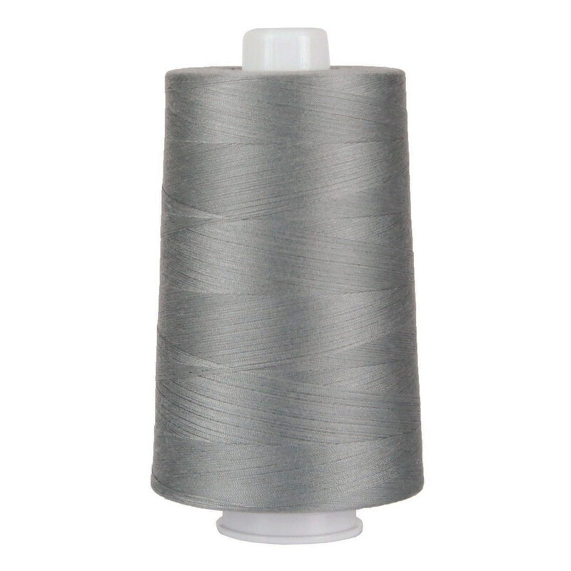 Large spool of gray thread on a white background