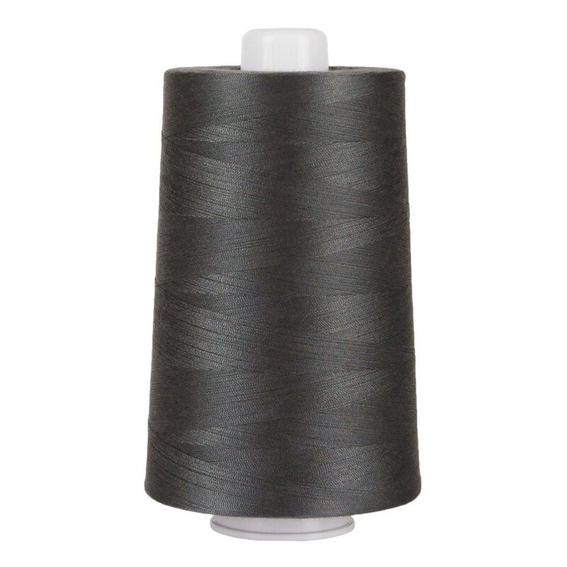 Large spool of dark gray thread on a white background