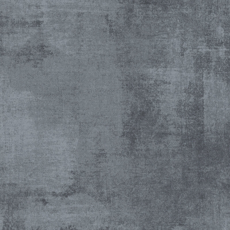 muted denim blue fabric featuring darker denim blue dry-brushed texturing