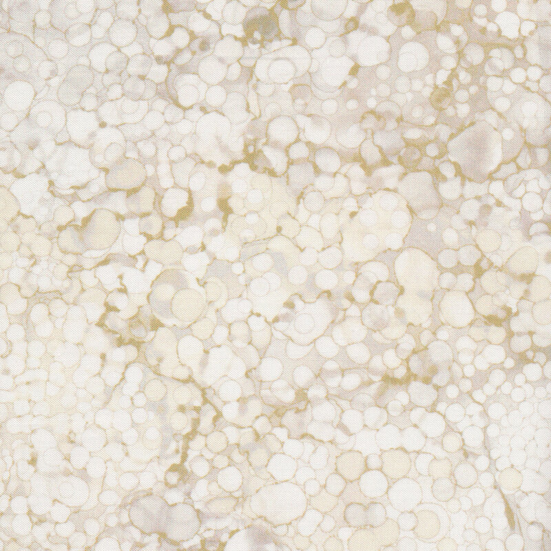 wide cream fabric featuring dark cream mottling and circles on an off-white background