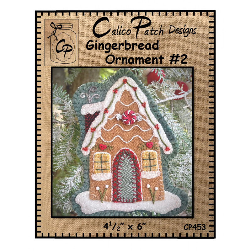The front of the Gingerbread Ornament #2 pattern showing the finished ornament with 2 glowing windows and a wrapped candy above the door, staged on a christmas tree