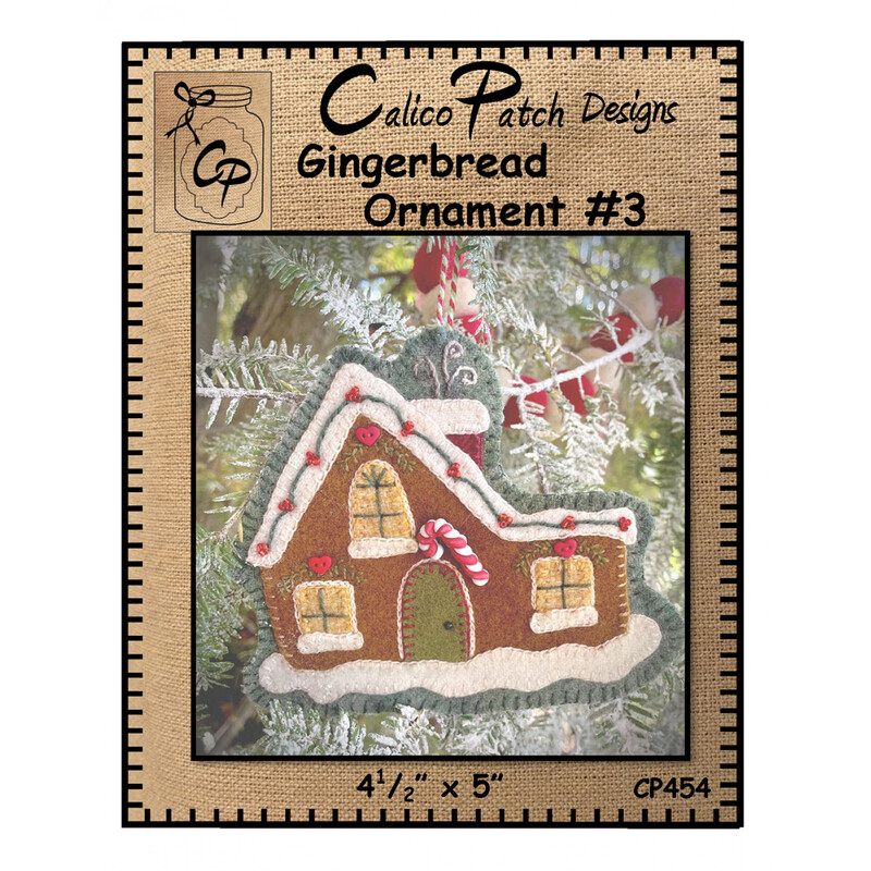 The front of the Gingerbread Ornament #3 pattern showing the finished ornament with 3 glowing windows and a candy cane above the door, staged on a christmas tree