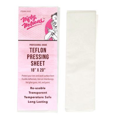 Overhead snapshot of the teflon pressing sheet beside the pink packaging for the sheet