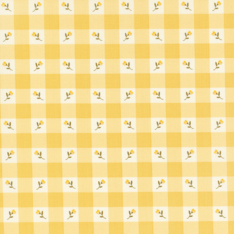 Swatch of light yellow gingham fabric with placed yellow flowers