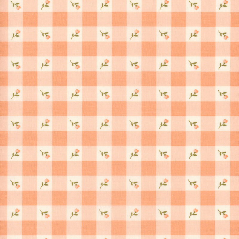 Swatch of peach gingham fabric with placed peach flowers