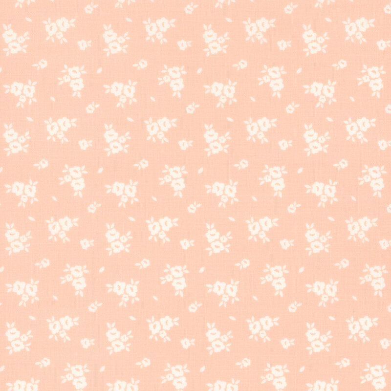 Swatch of light pink fabric with scattered white flower silhouettes 
