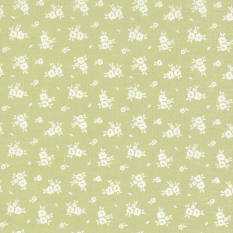 Swatch of light green fabric with scattered white flower silhouettes 
