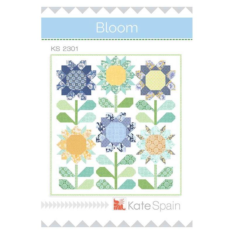 Front of Bloom pattern cover, depicting a quilt with six large flowers on it