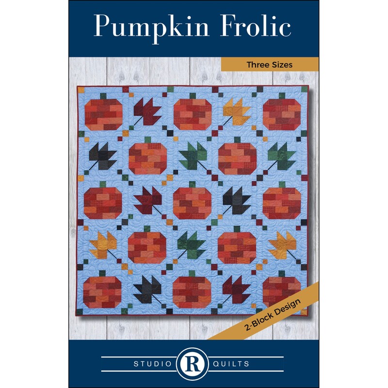 Front of Pumpkin Frolic pattern, displaying the finished quilt of deep orange pumpkins and maple leaves on a blue background