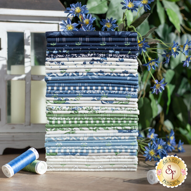 Stack of white, tan, green, and blue floral fabrics from the shoreline collection
