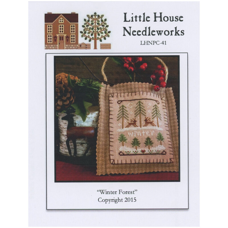 Front of pattern showing the completed small cross stitch ornament staged with a reindeer decoration