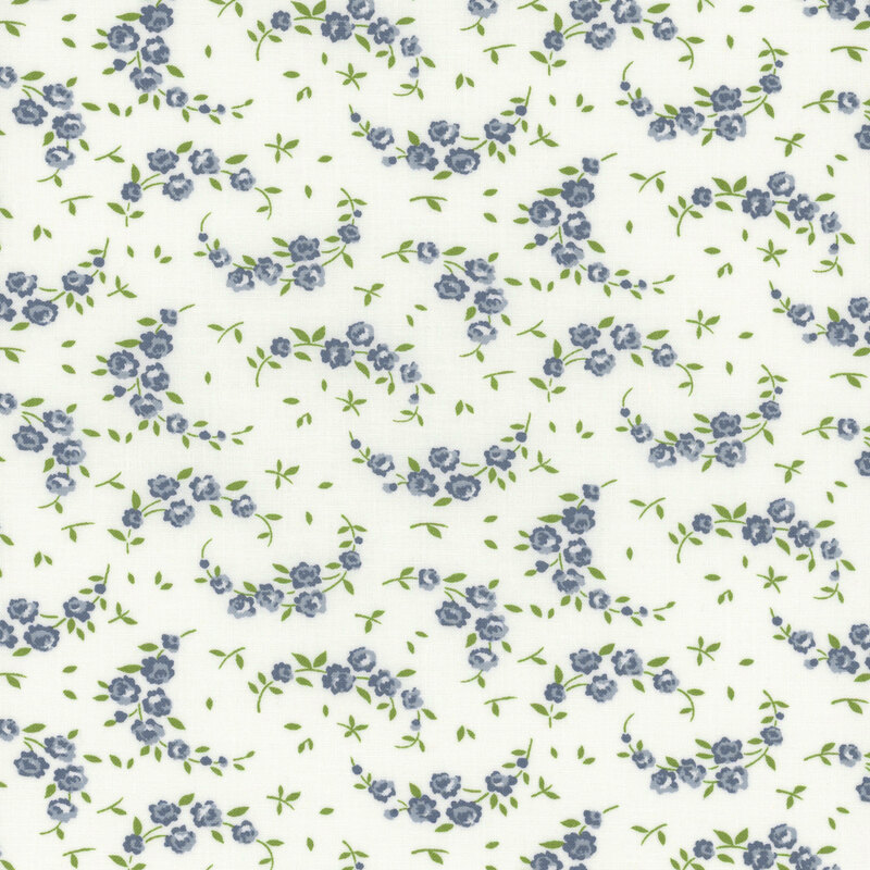 light cream fabric with scattered leaves and crescent shaped vines with blue flowers