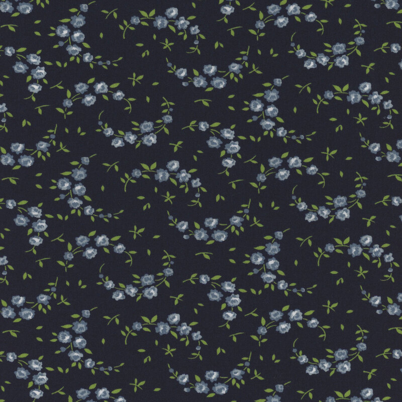 navy blue fabric with scattered leaves and crescent shaped vines with blue flowers
