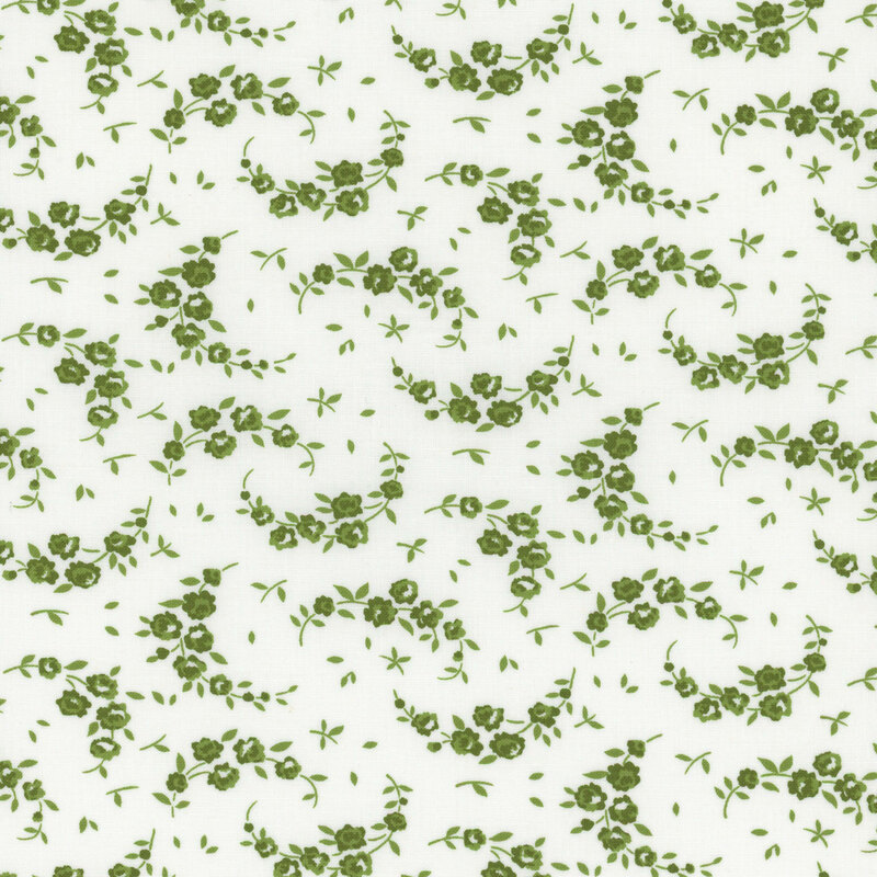 light cream fabric with scattered meadow green leaves and flowering crescent shaped vines