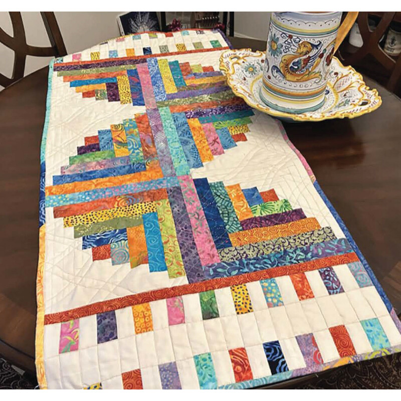 The finished table runner staged on a dining table next to a samovar