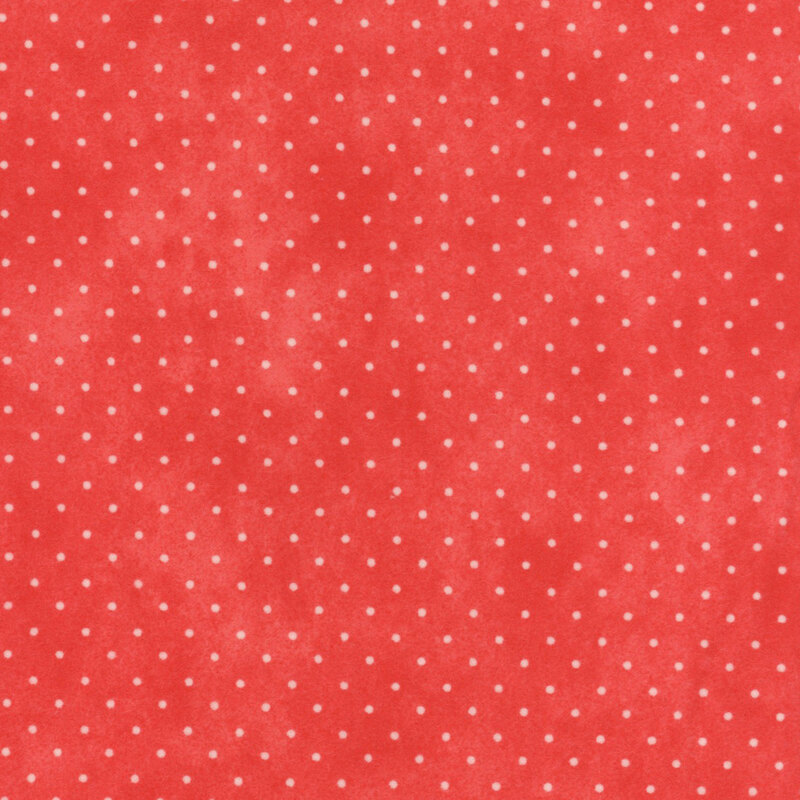 Mottled red fabric with small white polka dots.