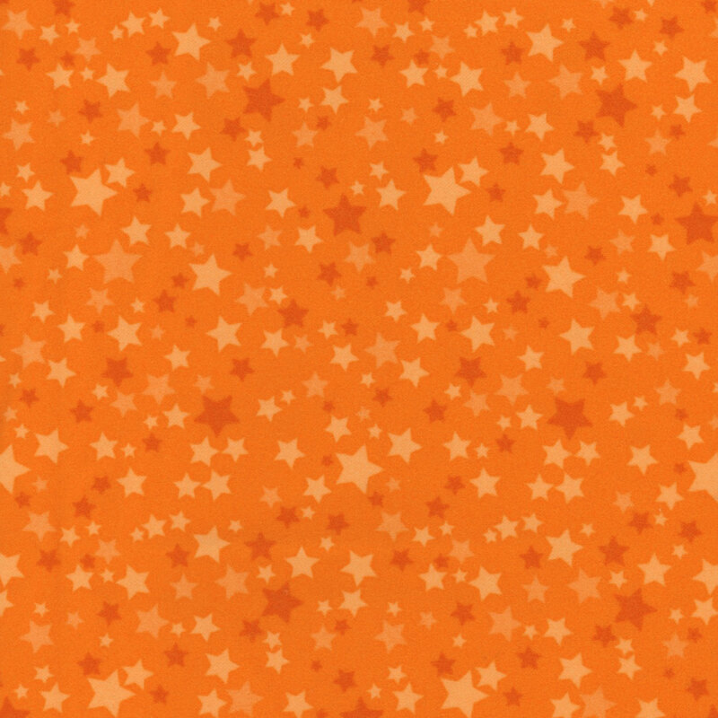 Orange fabric with a variety of orange stars.