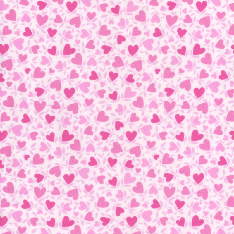 White fabric with a pattern of pink hearts.