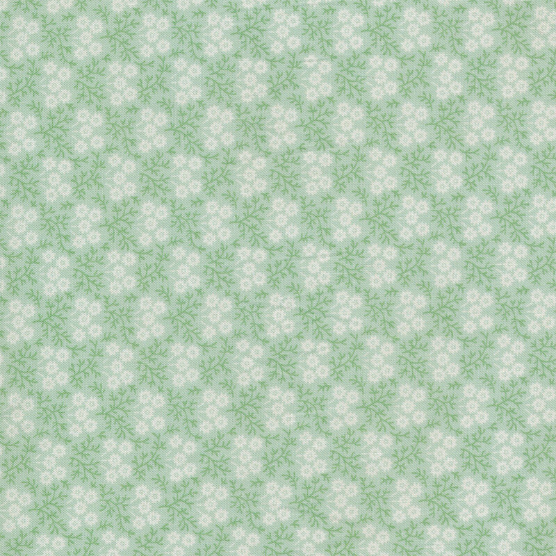 Floral print with small white flowers against a light green fabric.