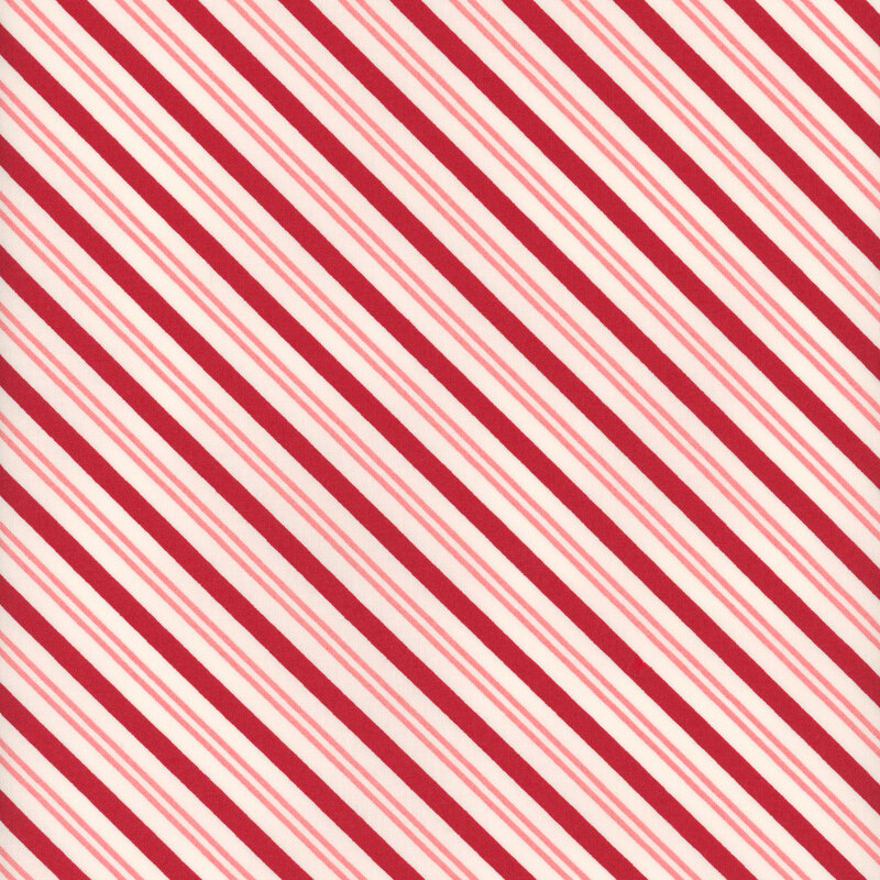 White fabric with diagonal stripes of varying widths in pink and red