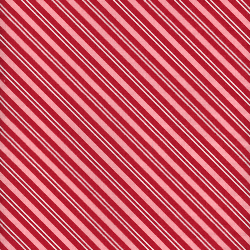 Pink fabric with diagonal stripes of varying widths in pink and red