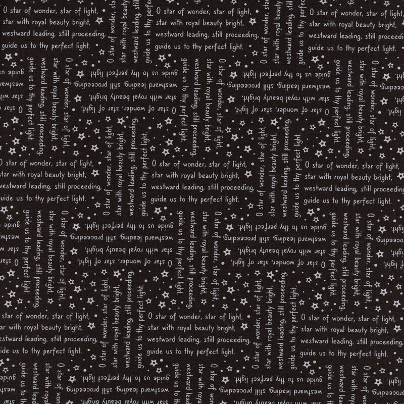 Black fabric with lines from the We Three Kings Christmas carol in gray arranged in stanzas perpendicular to one another.