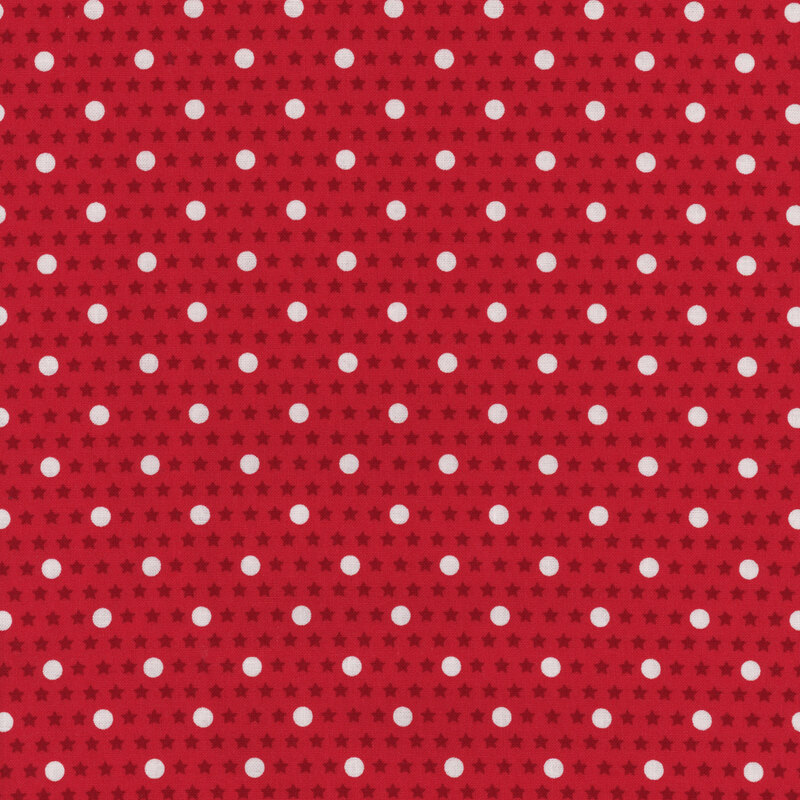 Red fabric with white polka dots with dark red stars in the background
