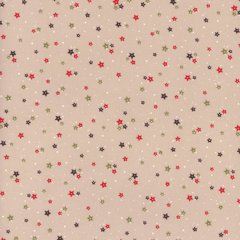 Taupe fabric with clusters of red and green stars with tiny white dots scattered in the background