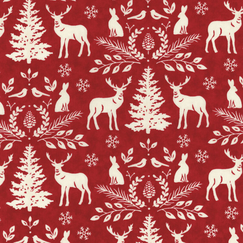 lovely red watercolor fabric with white woodland motifs, including deer, rabbits, birds, snowflakes, and pine trees