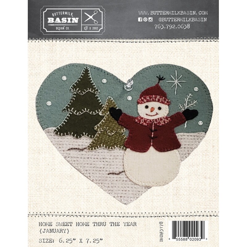 Front of pattern depicting a woolen snowman in the snowy foreground with a snowy sky and trees behind him