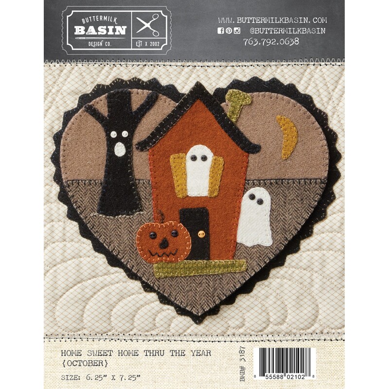 Front of pattern with finished heart featuring haunted house with ghosts and a jack o lantern