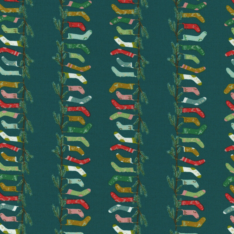 teal fabric with rows of fir branches with hanging stockings in shades of pink, red, green, and aqua