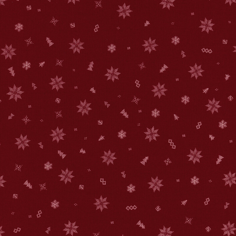 burgundy fabric with scattered embroidery style white snowflakes, quilting stars, and trees