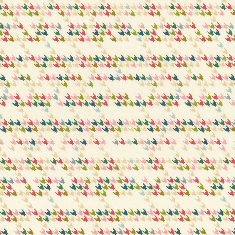 cream fabric with a modern interpretation of the houndstooth design in shades of cream, teal, aqua, green, pink, and red