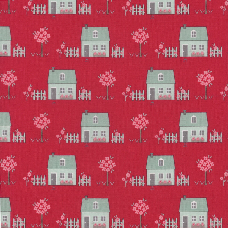 fabric with houses and trees in shades of blue and pink on red background