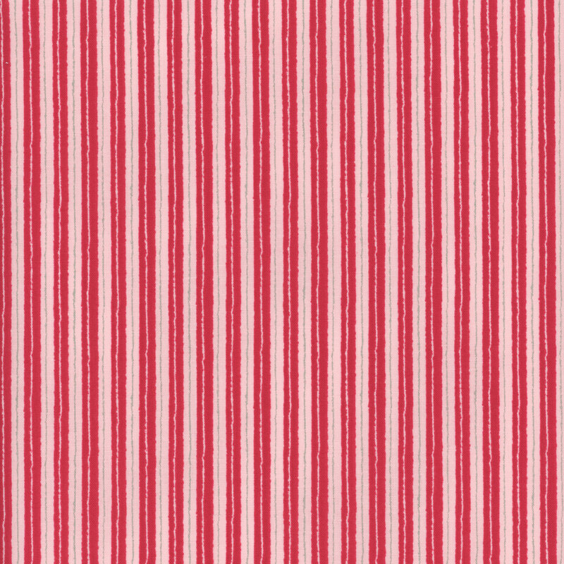 fabric with unsteady red and pink stripes, giving it a hand drawn charm
