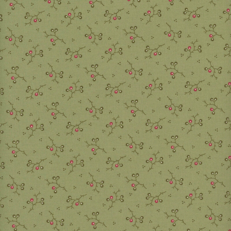 Green fabric with small red and dark green branches bearing fruit tossed all over with dot embellishments