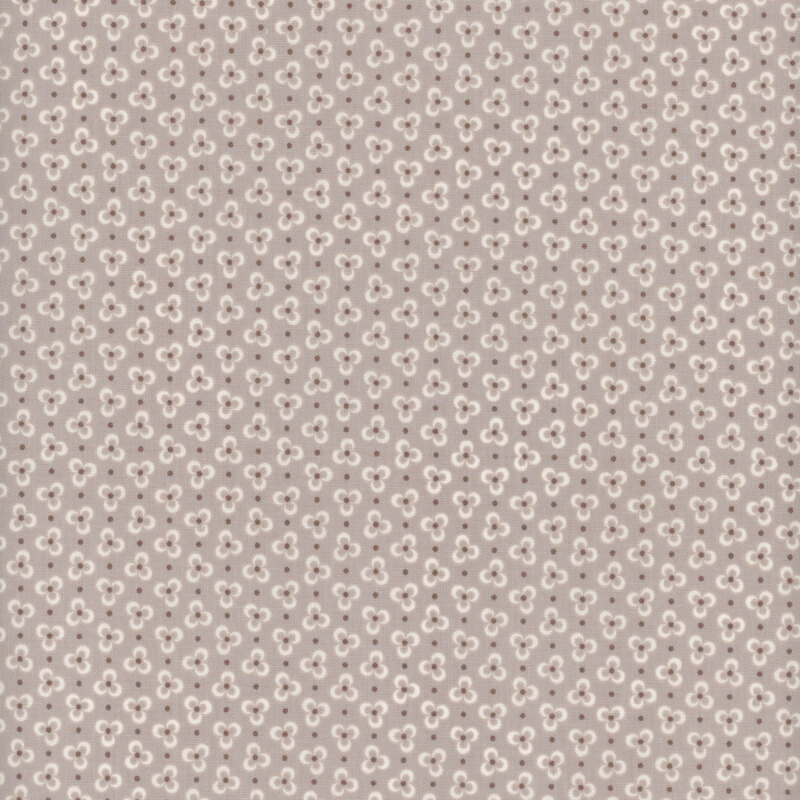 Cream three-petaled flowers on a stone gray background,  accented with dark gray polka dots