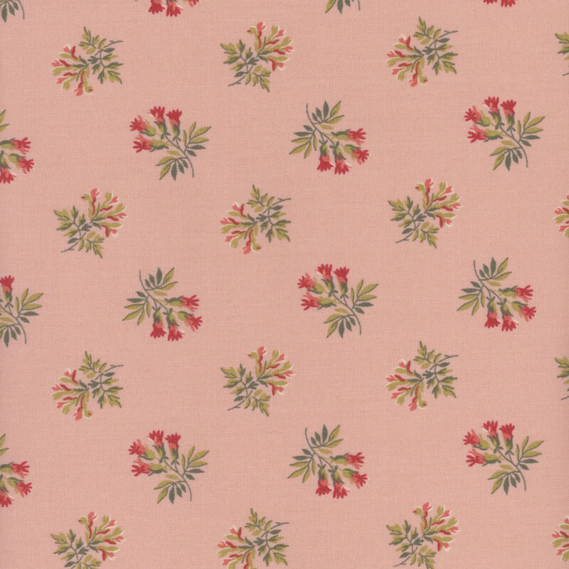 Pink fabric with small bunches of orange, red, and green flowers tossed all over