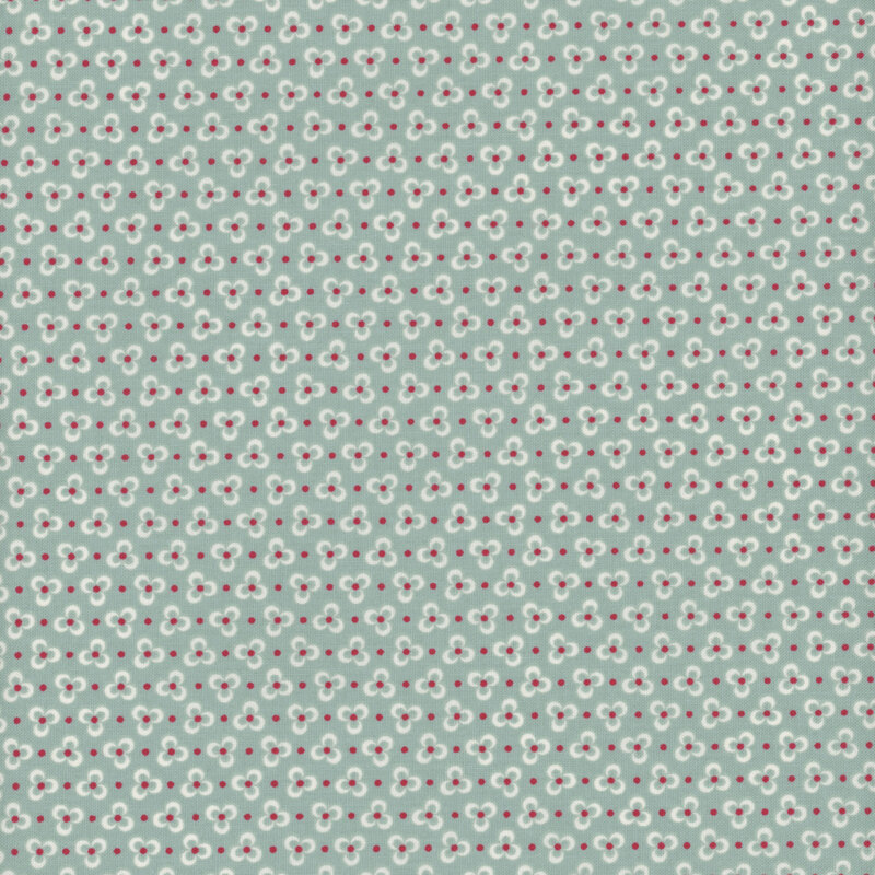Cream three-petaled flowers on an aqua fabric, accented with red polka dots