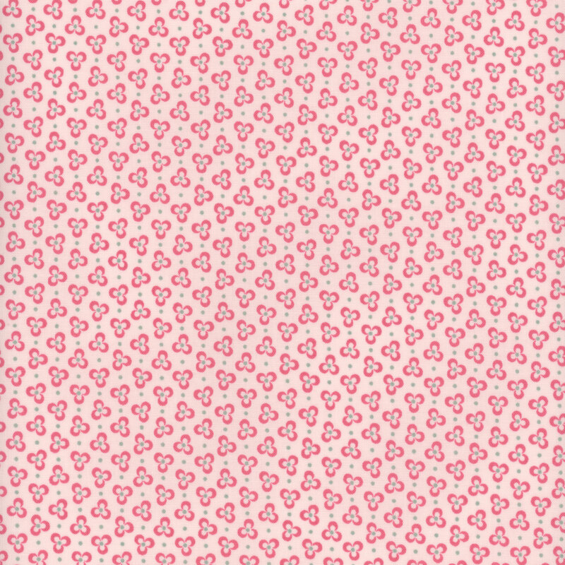 Pink three-petaled flowers on a blush pink fabric, accented with teal polka dots
