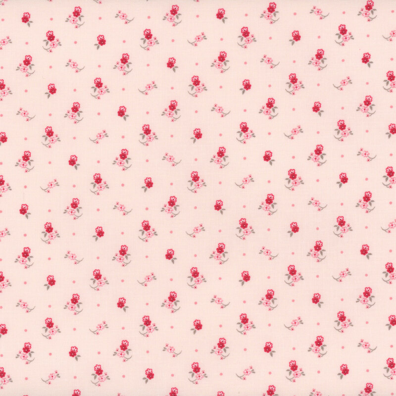 Small pink and red floral motifs, like little corsages tossed onto a pastel pink fabric