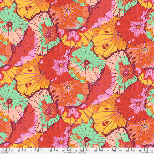 Fabric featuring vibrant pink, red, yellow, and mint green overlapping lotus leaves