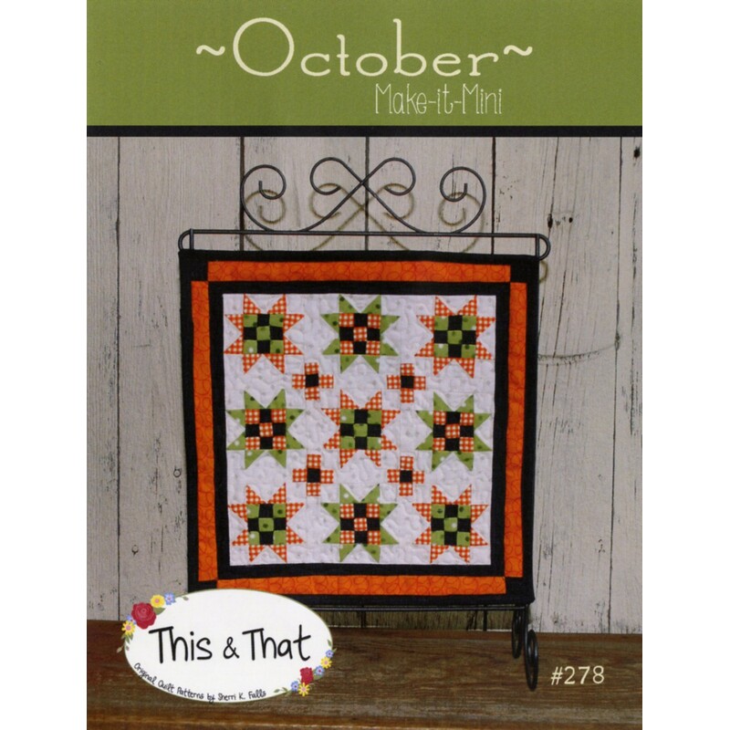 Front cover of pattern, showing the finished wallhanging hung from a craft scroll, staged in front of wood panels