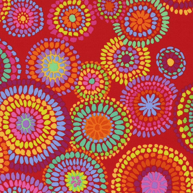 Fabric featuring a vibrant rainbow of colorful mosaic styled circles over a red background