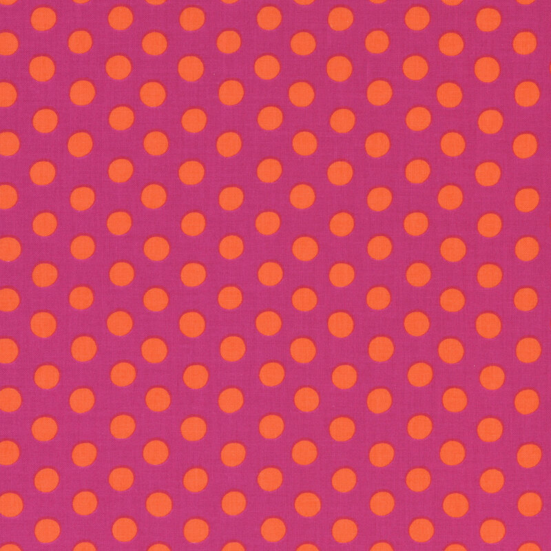Fabric featuring vibrant orange polka dots over a red background