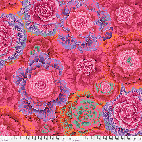 Fabric featuring vibrant pink and purple cabbages accented by orange and mint green cabbage leaves